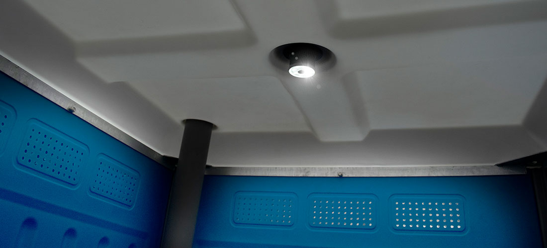 a led solar light on the ceiling of a portable toilet